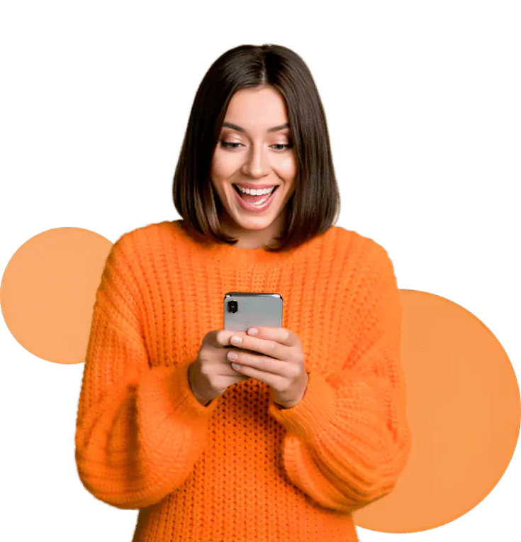 A lady is happy while using her phone