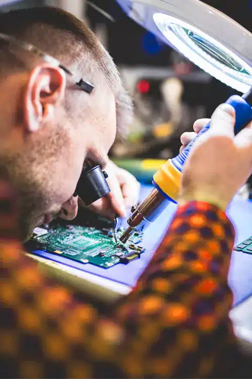 Man soldering motherboard