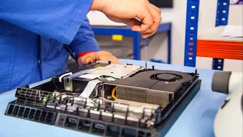 Man fixing the disk drive of a PS4