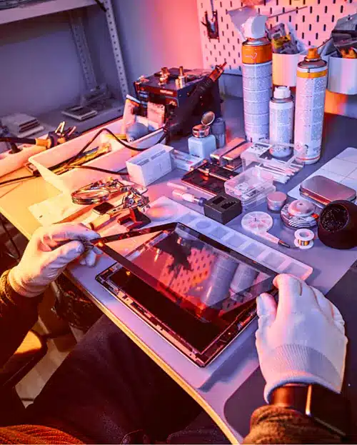 Technician repairs broken tablet with tools